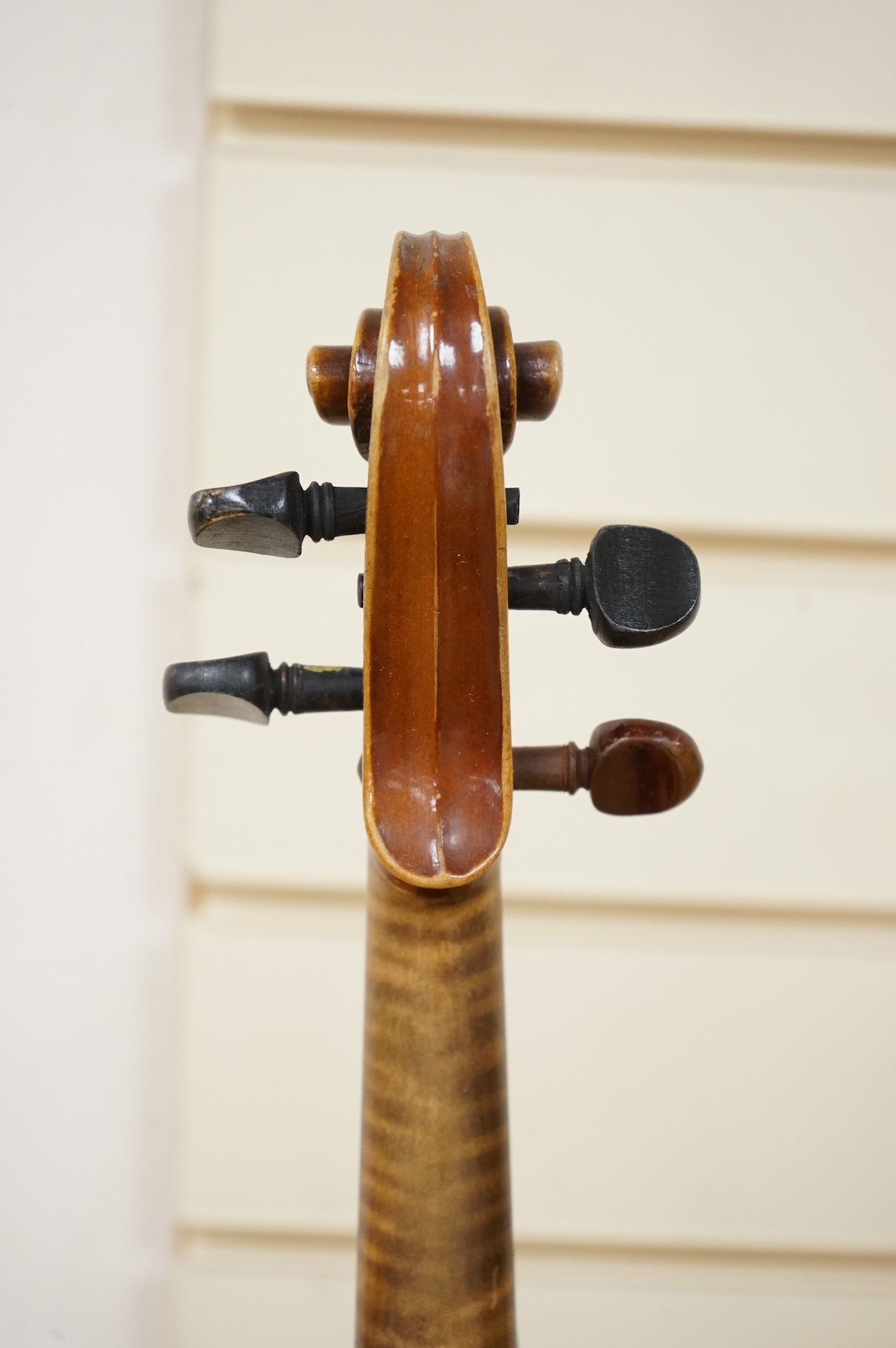 Five cased 20th century violins, including; a German violin, two Czech violins, a three-quarter size violin with a label for Bienfait, and a Romanian quarter size violin, all in cases or the remains of cases.